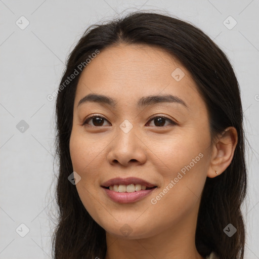 Joyful asian young-adult female with long  brown hair and brown eyes