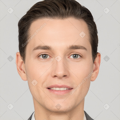 Joyful white young-adult male with short  brown hair and grey eyes