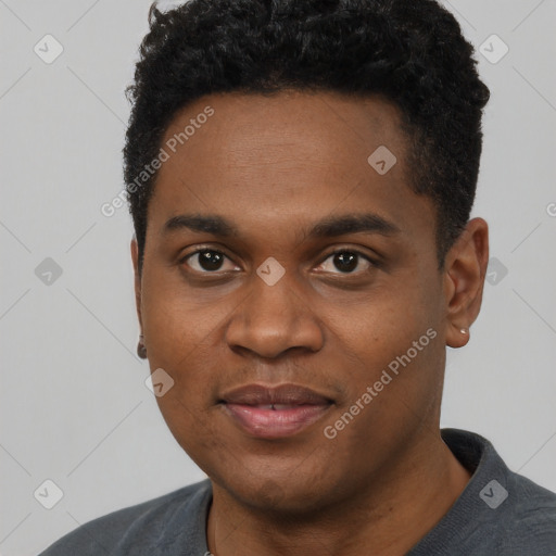 Joyful black young-adult male with short  black hair and brown eyes