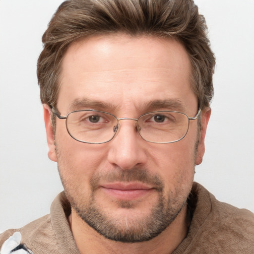 Joyful white adult male with short  brown hair and grey eyes