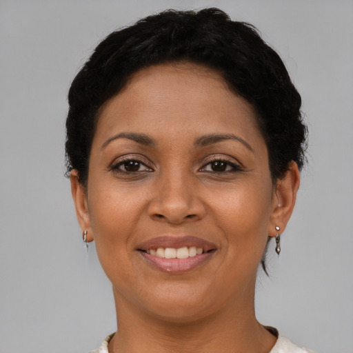 Joyful latino young-adult female with short  brown hair and brown eyes
