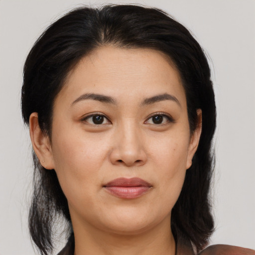 Joyful asian adult female with medium  brown hair and brown eyes