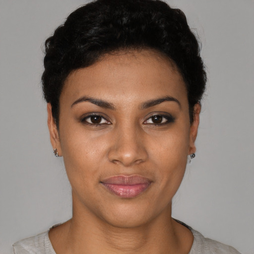 Joyful black young-adult female with short  black hair and brown eyes