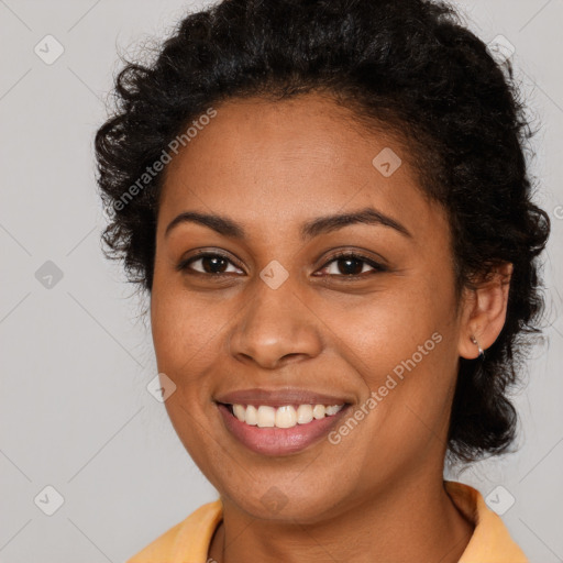 Joyful black young-adult female with long  brown hair and brown eyes