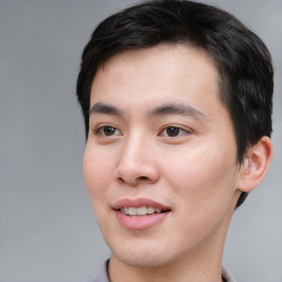 Joyful asian young-adult male with short  brown hair and brown eyes