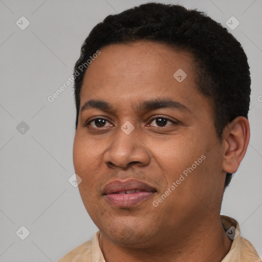 Joyful latino young-adult male with short  black hair and brown eyes