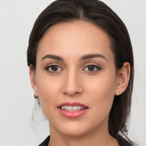 Joyful white young-adult female with long  brown hair and brown eyes