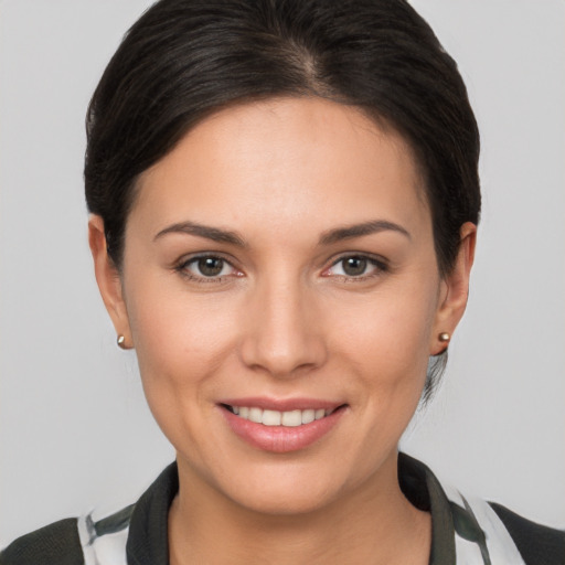 Joyful white young-adult female with short  brown hair and brown eyes