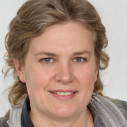 Joyful white adult female with medium  brown hair and grey eyes