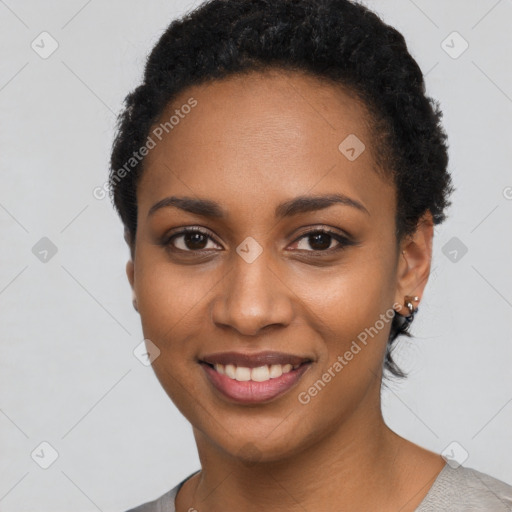 Joyful black young-adult female with short  black hair and brown eyes