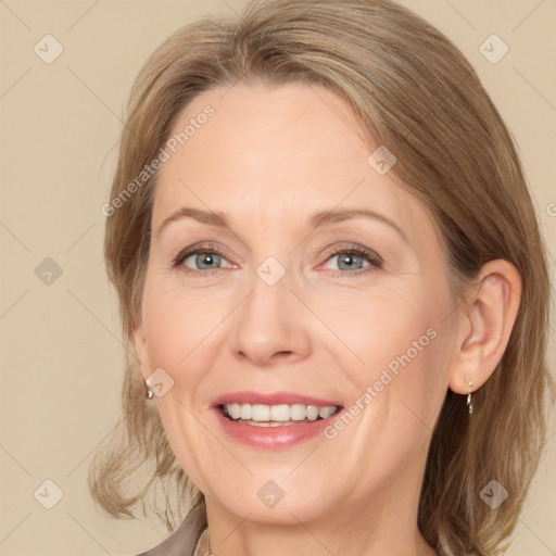 Joyful white adult female with medium  brown hair and grey eyes