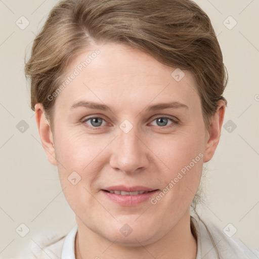 Joyful white young-adult female with short  brown hair and grey eyes