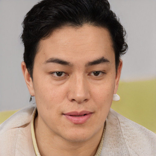 Joyful latino young-adult male with short  brown hair and brown eyes