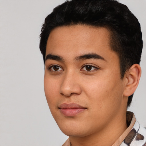 Joyful asian young-adult male with short  black hair and brown eyes
