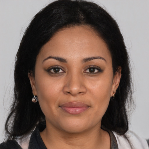 Joyful latino young-adult female with long  brown hair and brown eyes