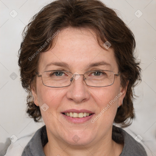 Joyful white adult female with medium  brown hair and blue eyes