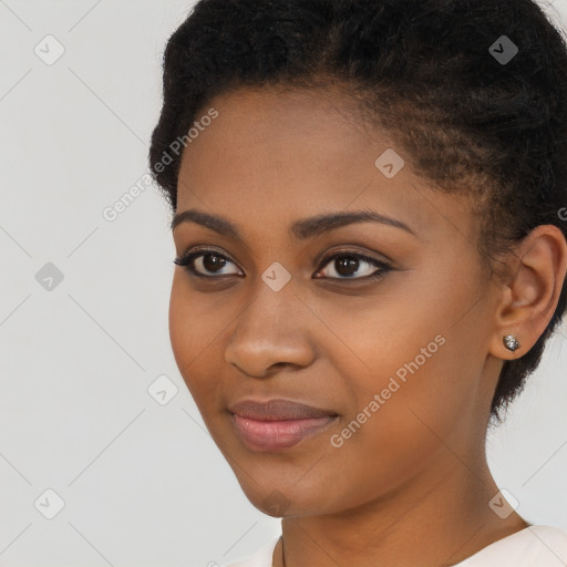 Joyful black young-adult female with short  black hair and brown eyes