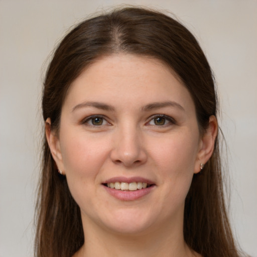 Joyful white young-adult female with long  brown hair and grey eyes