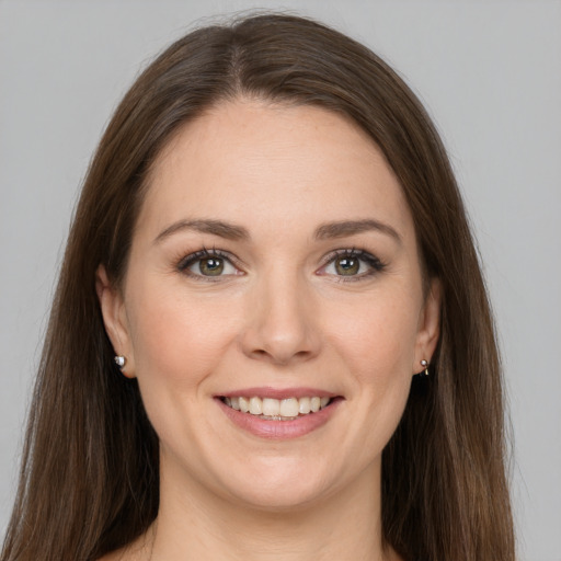 Joyful white young-adult female with long  brown hair and grey eyes