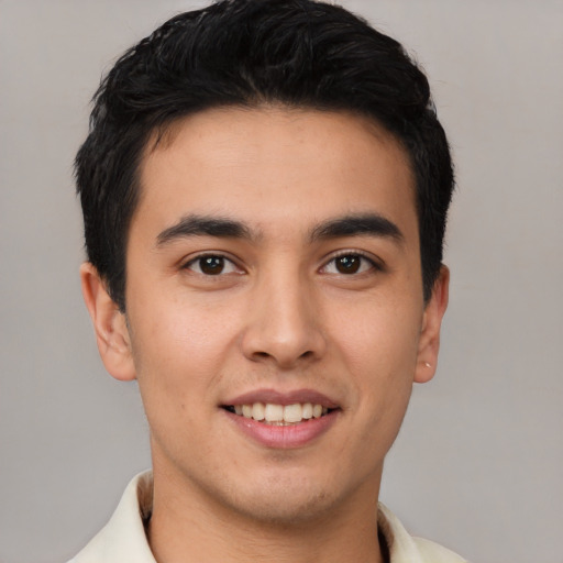 Joyful latino young-adult male with short  brown hair and brown eyes