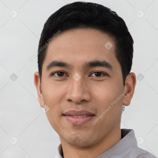 Joyful latino young-adult male with short  black hair and brown eyes