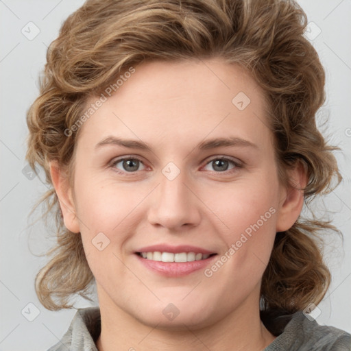 Joyful white young-adult female with medium  brown hair and blue eyes