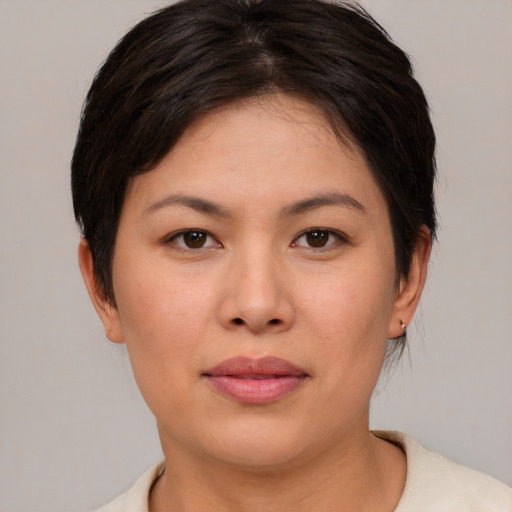 Joyful asian young-adult female with short  brown hair and brown eyes