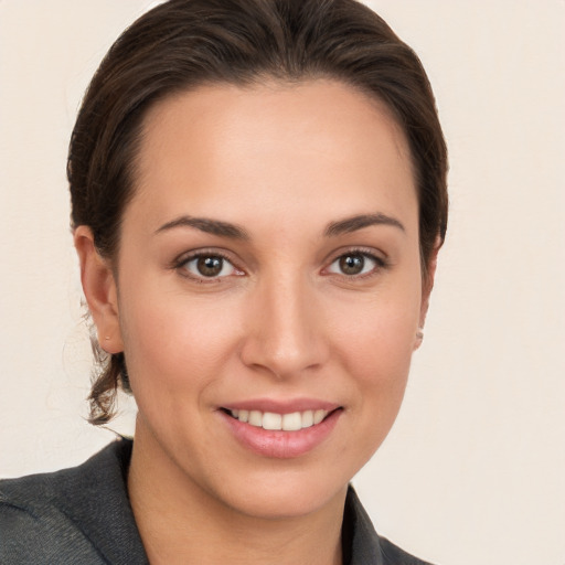 Joyful white young-adult female with medium  brown hair and brown eyes