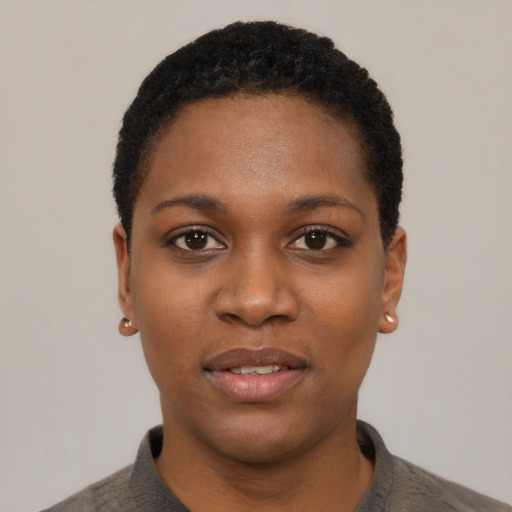 Joyful black young-adult female with short  black hair and brown eyes