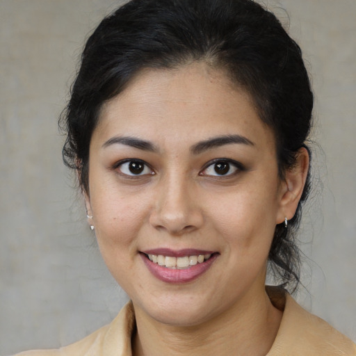 Joyful latino young-adult female with medium  brown hair and brown eyes