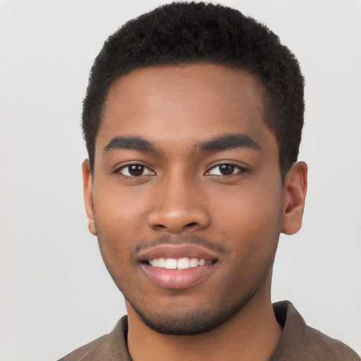 Joyful black young-adult male with short  brown hair and brown eyes