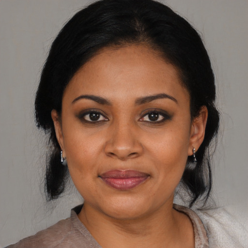 Joyful black young-adult female with medium  black hair and brown eyes