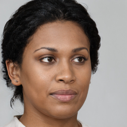 Joyful black young-adult female with medium  brown hair and brown eyes