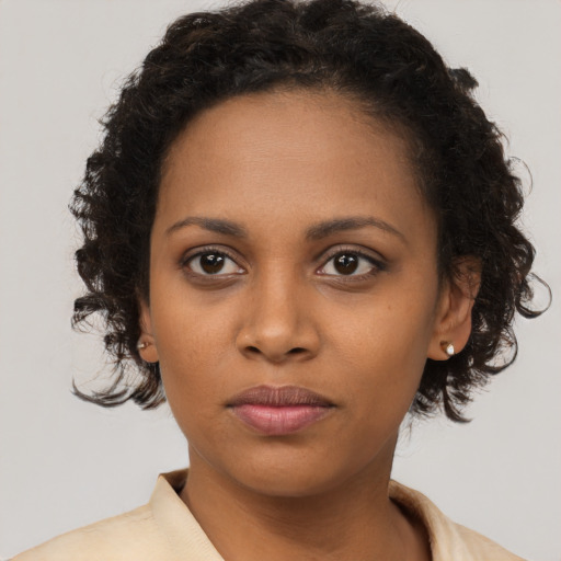 Joyful black young-adult female with medium  brown hair and brown eyes