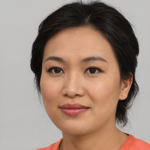 Joyful asian young-adult female with medium  brown hair and brown eyes