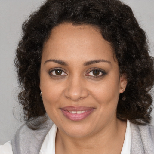 Joyful black young-adult female with medium  brown hair and brown eyes