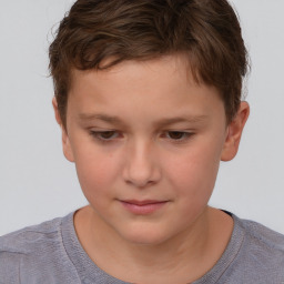 Joyful white child male with short  brown hair and brown eyes