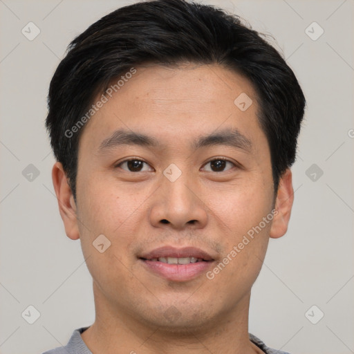 Joyful asian young-adult male with short  brown hair and brown eyes