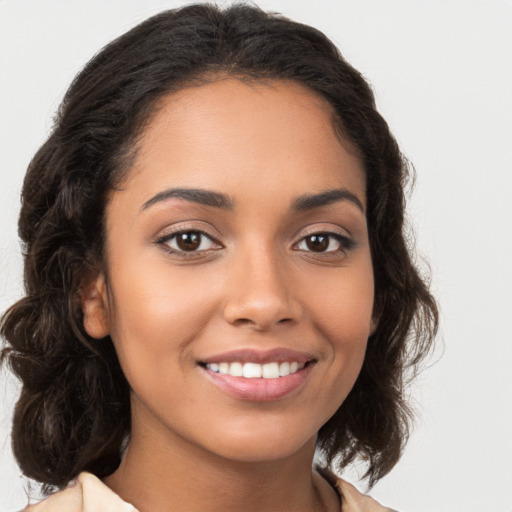 Joyful latino young-adult female with medium  brown hair and brown eyes