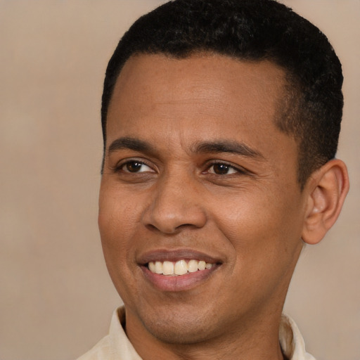 Joyful latino young-adult male with short  black hair and brown eyes