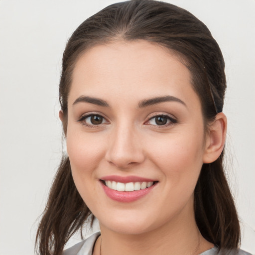 Joyful white young-adult female with long  brown hair and grey eyes