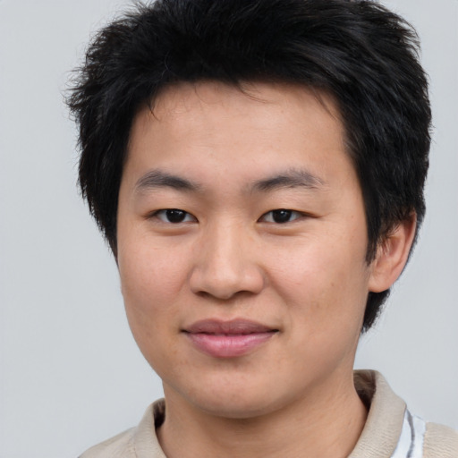 Joyful asian young-adult male with short  brown hair and brown eyes
