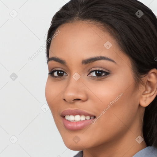 Joyful latino young-adult female with long  brown hair and brown eyes