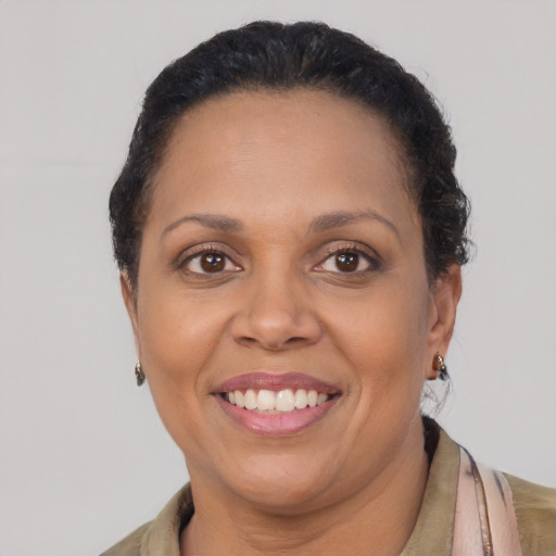 Joyful latino adult female with short  brown hair and brown eyes