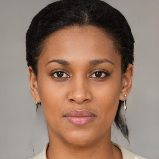Joyful black young-adult female with short  brown hair and brown eyes