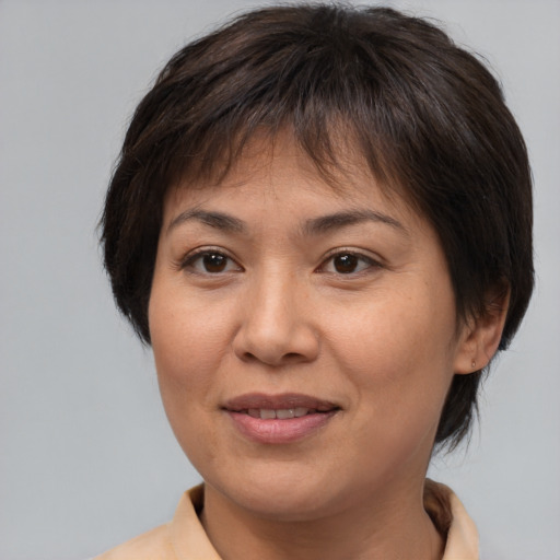 Joyful asian adult female with medium  brown hair and brown eyes