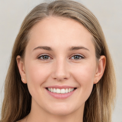 Joyful white young-adult female with long  brown hair and grey eyes