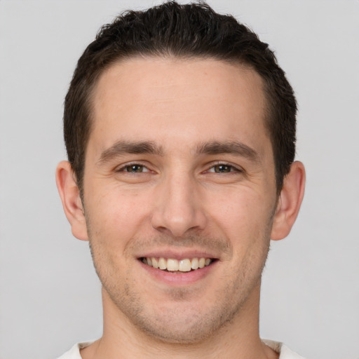 Joyful white young-adult male with short  brown hair and brown eyes