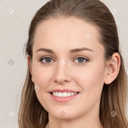 Joyful white young-adult female with long  brown hair and grey eyes