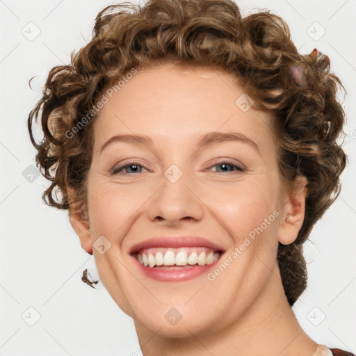 Joyful white young-adult female with medium  brown hair and blue eyes